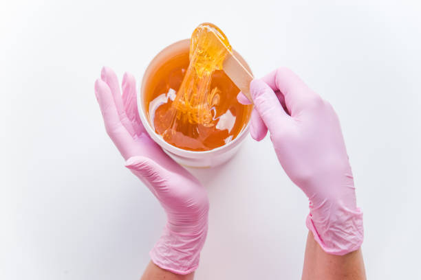 sugaring concept. flat lay. overhead view of bowl with cosmetology honey - staple remover imagens e fotografias de stock