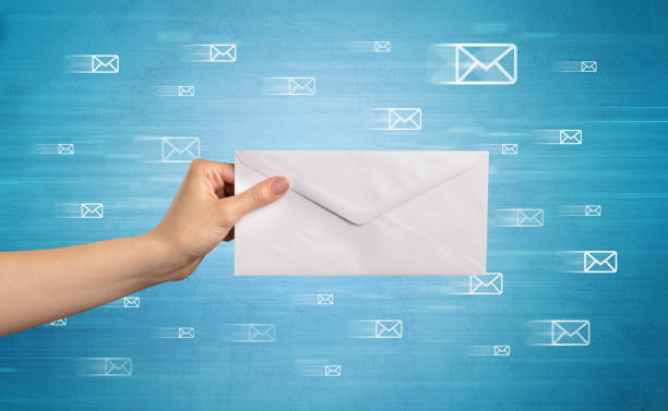 istock Hand holding envelope with message symbols around 1151160915