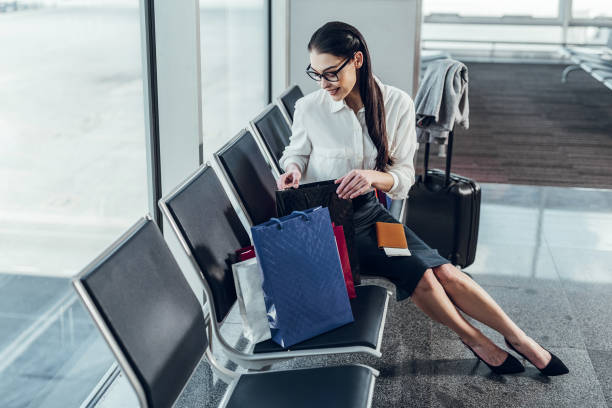 istock Cheerful lady is taking her luggage to get on plane 1151161999