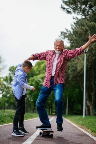 istock Grandfather and grandson having fun, skateboarding 1151162190