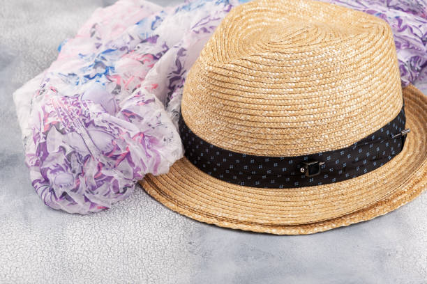 istock Straw hat with a silk scarf on a light background. 1151162398