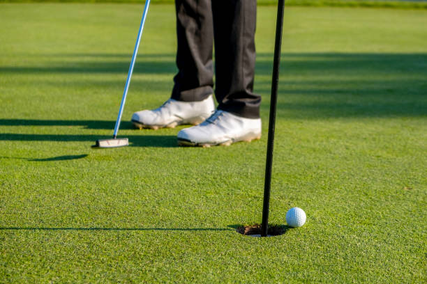 istock Golf player hits the ball into the hole 1151163494