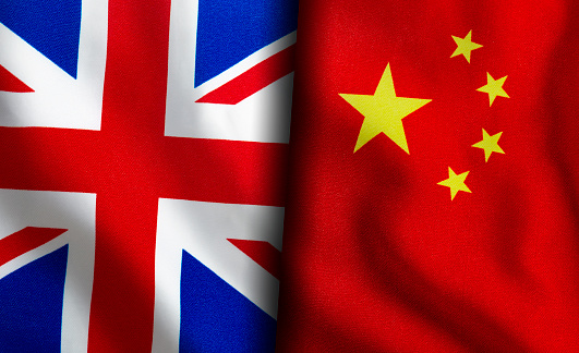 British and Chinese flags standing side by side
