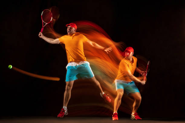 istock One caucasian man playing tennis on black background 1151165319