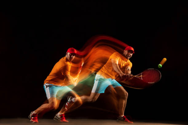 istock One caucasian man playing tennis on black background 1151165320