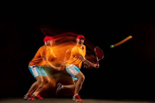 istock One caucasian man playing tennis on black background 1151165321