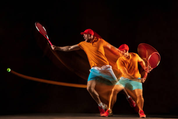 istock One caucasian man playing tennis on black background 1151165337