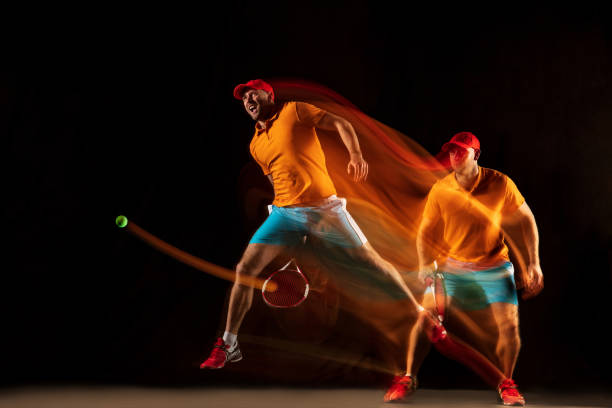 istock One caucasian man playing tennis on black background 1151165342