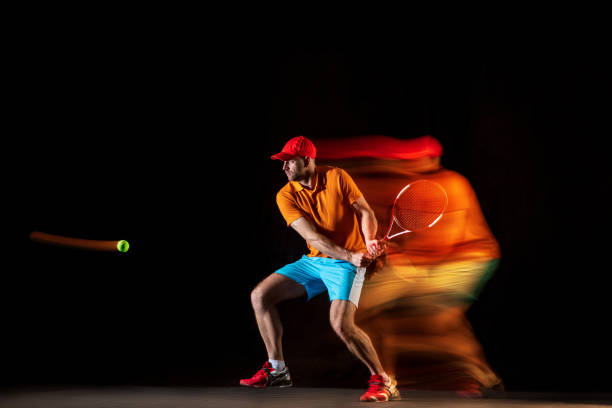istock One caucasian man playing tennis on black background 1151165351