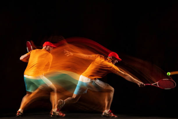 istock One caucasian man playing tennis on black background 1151165353