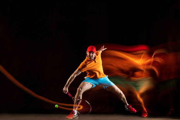 istock One caucasian man playing tennis on black background 1151165361