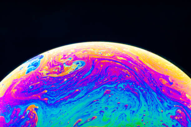 istock Macro shot of a soap bubble hemisphere. Abstract colorful liquid background. 1151165437