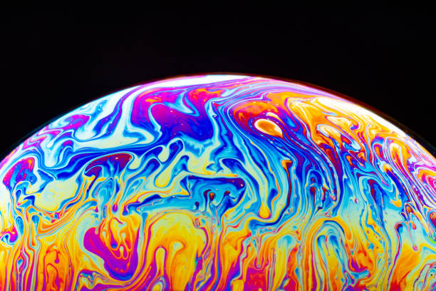 istock Macro shot of a soap bubble hemisphere. Abstract colorful liquid background. 1151165440