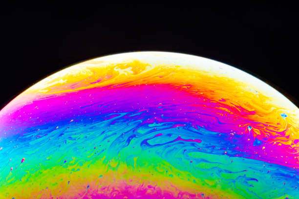 istock Macro shot of a soap bubble hemisphere. Abstract colorful liquid background. 1151165454