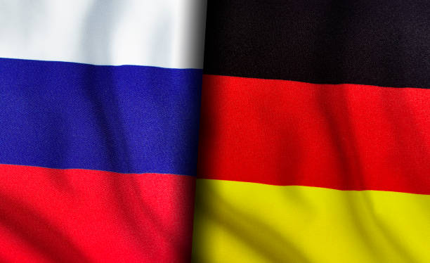 russian and german flags standing side by side - german culture imagens e fotografias de stock