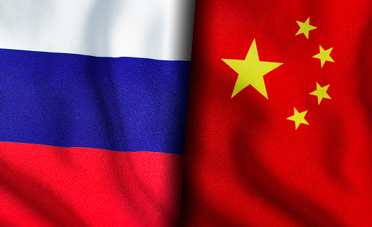 Russian and Chinese flags standing side by side