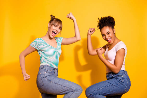 istock Close up side profile photo beautiful she her lady different nationalities celebrate hands arms fists raised up yell amazed wear casual white striped t-shirt clothes isolated yellow bright background 1151168432