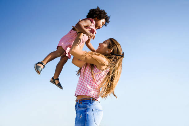 istock Beautiful young mother with her son having fun in the park. 1151170607