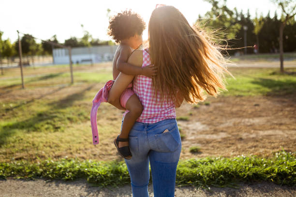 istock Beautiful young mother with her son having fun in the park. 1151170621