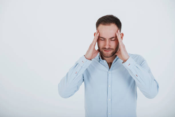 istock Having headache. Man in official clothes stands against white background in the studio 1151173801