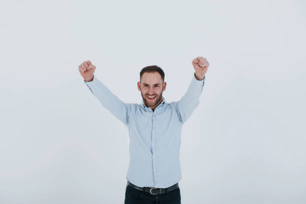 istock Expected success. Man in official clothes stands against white background in the studio 1151174143