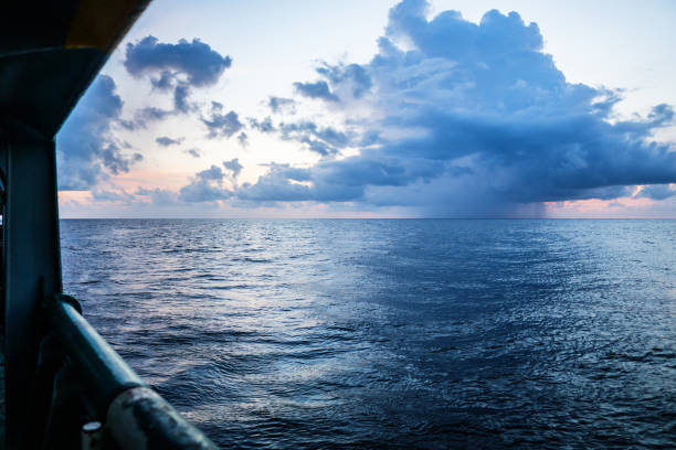 istock sunset, sea, the sun is covered with clouds. Open ocean view 1151174180