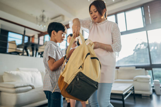 istock Woman preparing son for school 1151176639