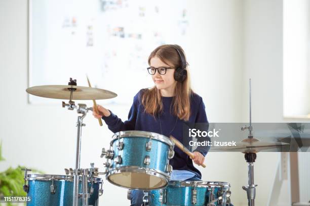 Confident Drummer Practicing In Training Class Stock Photo - Download Image Now - Drum Kit, Girls, Playing