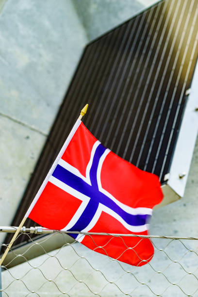 istock norwegian flag against solar panels 1151178411