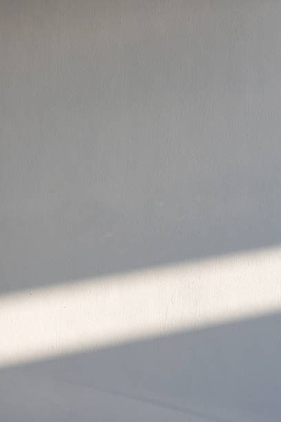 istock simplicity empty white cement wall with line of sun light and shadow at afternoon. used for template, background or texture. 1151178900