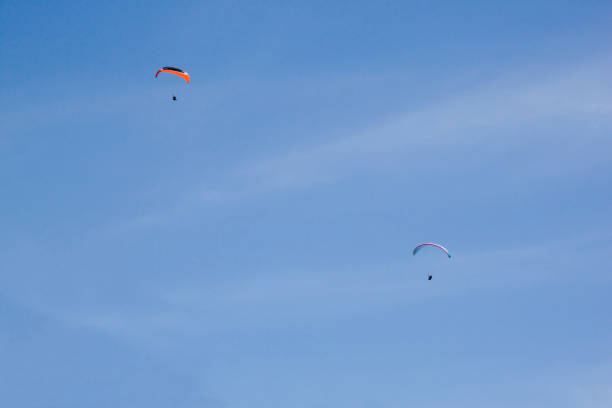 istock two parachutes flying in the sky very high 1151180065