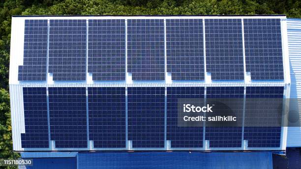 Commercial Building Factory Rooftop Installed Photovoltaic Solar Panels Stock Photo - Download Image Now