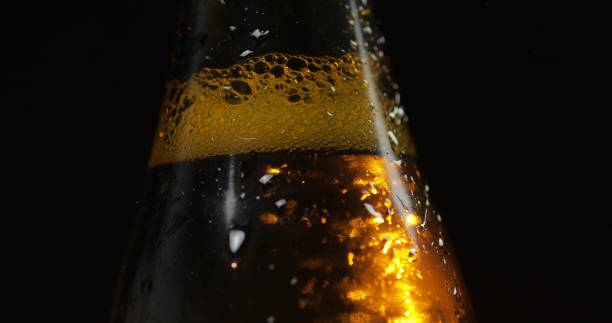 istock Bottle of cold beer on a black background. Condensate 1151182771