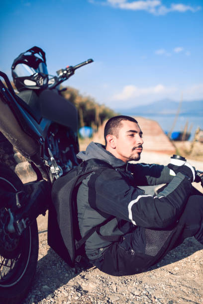 istock Nomad Biker Relaxing On Lake Pier 1151183002