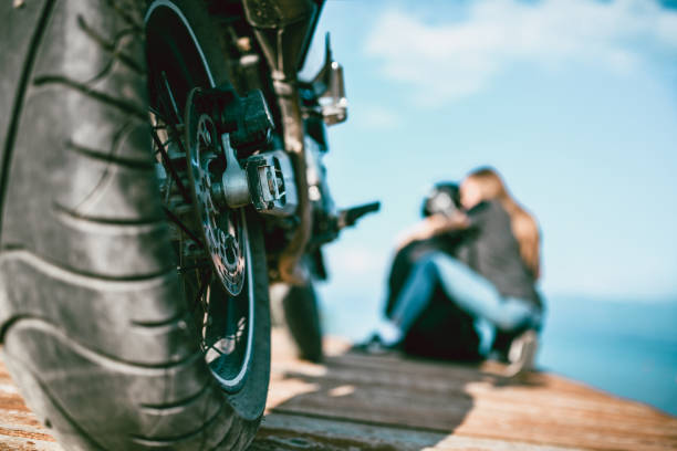 istock Couple Embracing While Taking A Break From Motorcycle Riding 1151183642