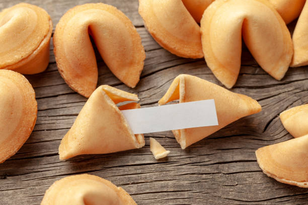 istock Chinese fortune cookies. Cookies pile with blank blank inside for words prediction. Background of old wooden table. 1151184376
