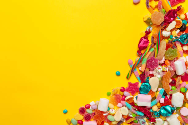 istock colored candies on yellow background 1151184732