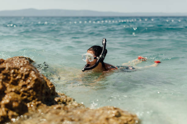 istock Female diver learning to dive at seashore. 1151186877