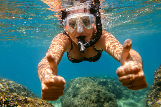 istock Woman snorkelling under water. 1151187122