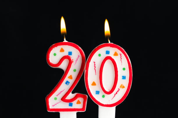 istock Colorful burning birthday candle  on dark background 1151188409