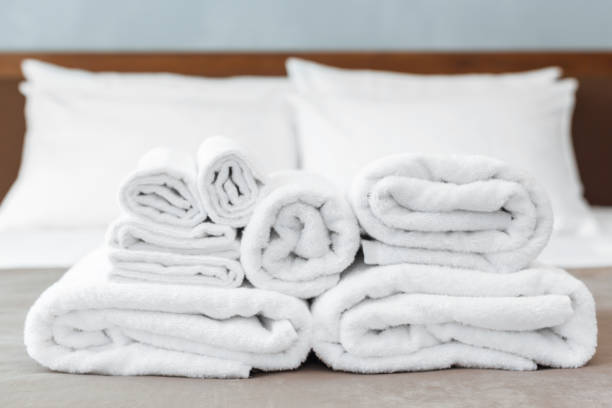 istock White towel on bed in guest room for hotel customer 1151190614