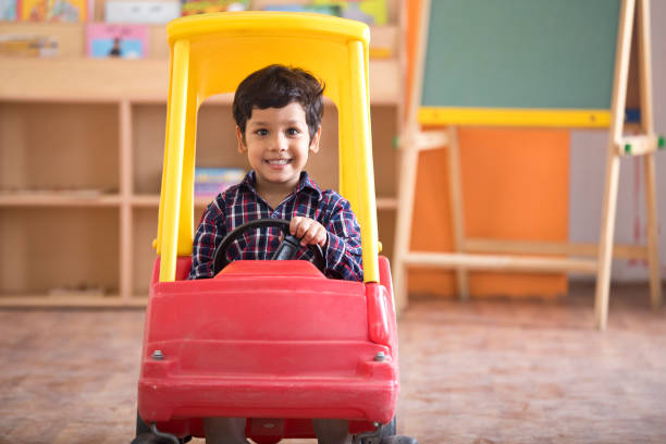 istock Boy riding toy car 1151190970