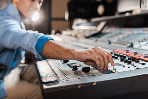 istock selective focus of mixed race sound producer working at mixing console 1151191165