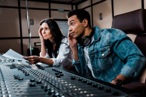 istock two thoughtful sound producers working at mixing console in recording studio 1151191453