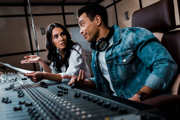 istock two quarrelling multicultural sound producers working at mixing console in recording studio 1151191462