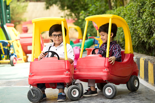 Preschool children enjoying toy car ride