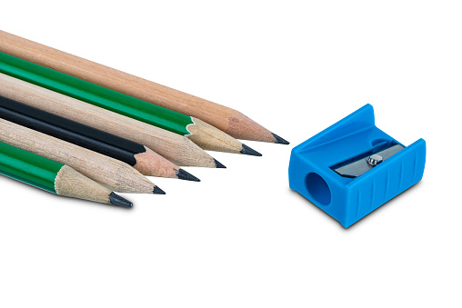 Colored pencil and pencil sharpener on white background