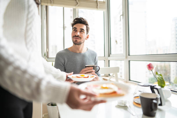 istock Unrecognizable woman bringing breakfast to boyfriend 1151192476