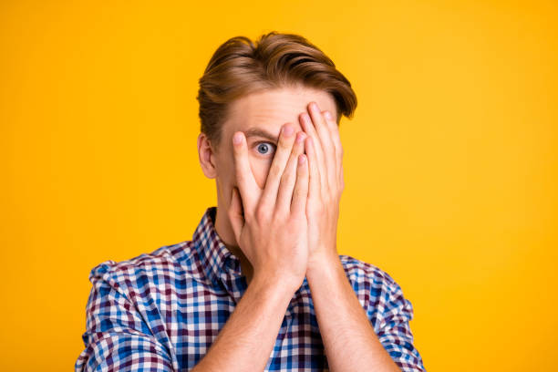 close up photo amazing he him his man arms fingers hiding eyes full fear oh no facial expression epic fail lost scary movie wear casual plaid checkered shirt outfit isolated yellow bright background - spy secrecy top secret mystery imagens e fotografias de stock