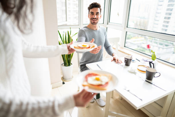 istock Unrecognizable woman bringing breakfast to boyfriend 1151192700